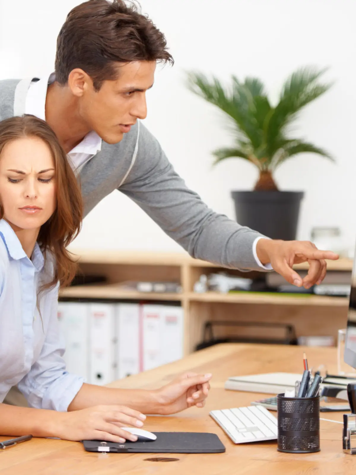 Shot of a male coworker acting inappropriately in the workplace