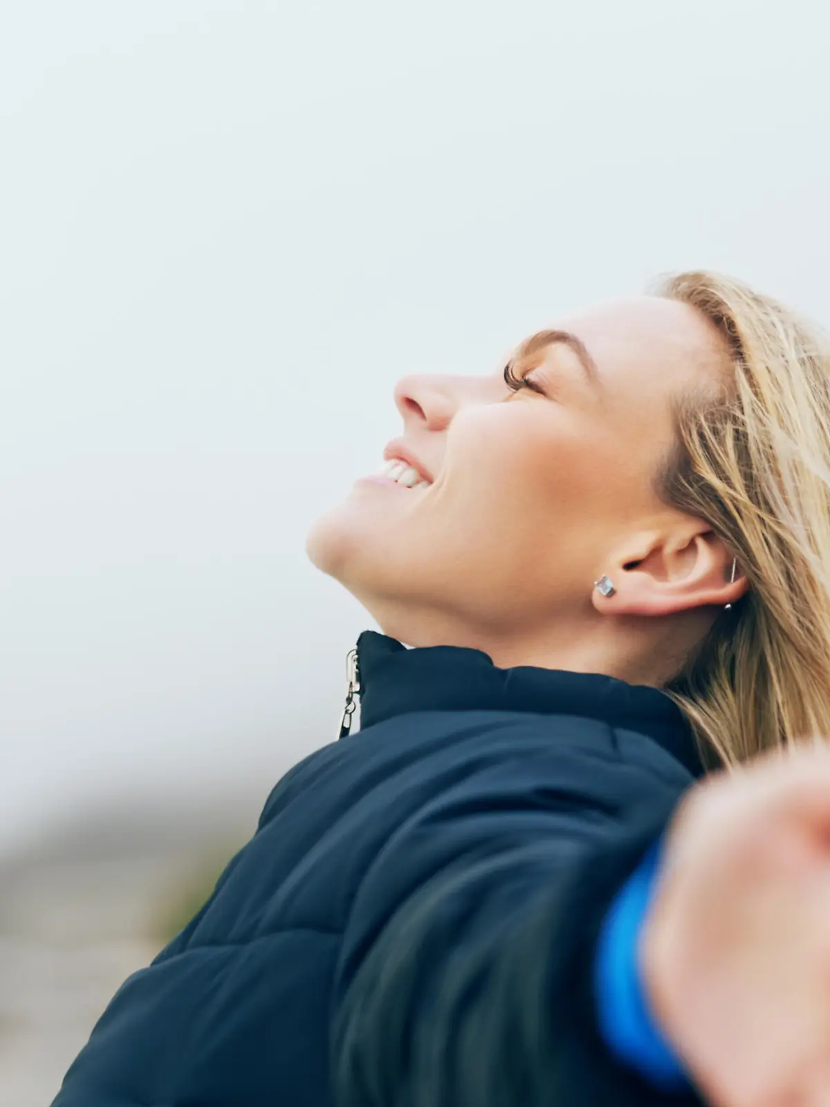 Happy woman, outdoor freedom arms out in wind, breathe fresh air or purpose, happiness and motivation, peace and dream, calm or hope. Smile lady, optimism and relax in nature, wellness or mindfulness