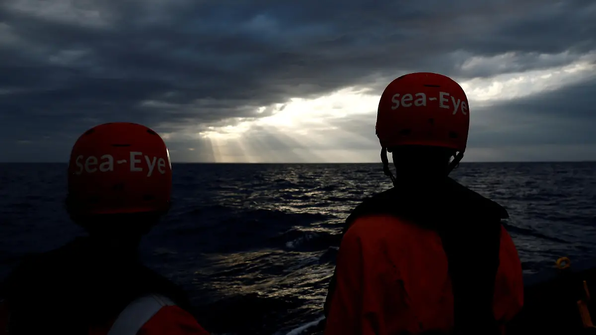 Crew members on the German NGO Sea-Eye migrant rescue ship 'Alan Kurdi' wait for Tunisian migrants to disembark to be transferred to Malta, in international waters off Malta in the central Mediterranean Sea, September 10, 2019. REUTERS/Darrin Zammit Lupi TPX IMAGES OF THE DAY