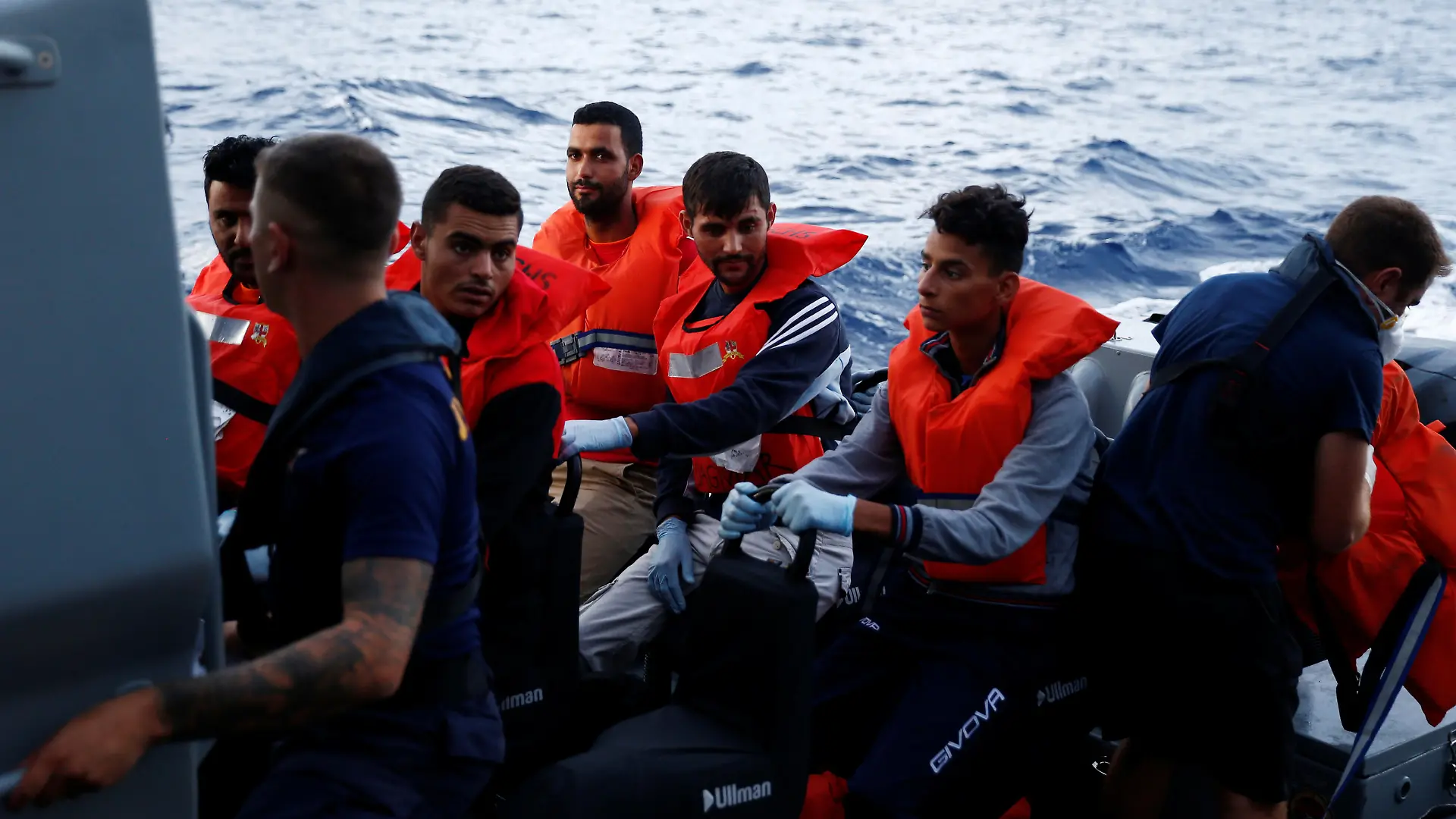 Tunisian migrants sit on an Armed Forces of Malta patrol vessel after disembarking from the German NGO Sea-Eye migrant rescue ship 'Alan Kurdi' to be transferred to Malta, in international waters off Malta in the central Mediterranean Sea, September 10, 2019. REUTERS/Darrin Zammit Lupi