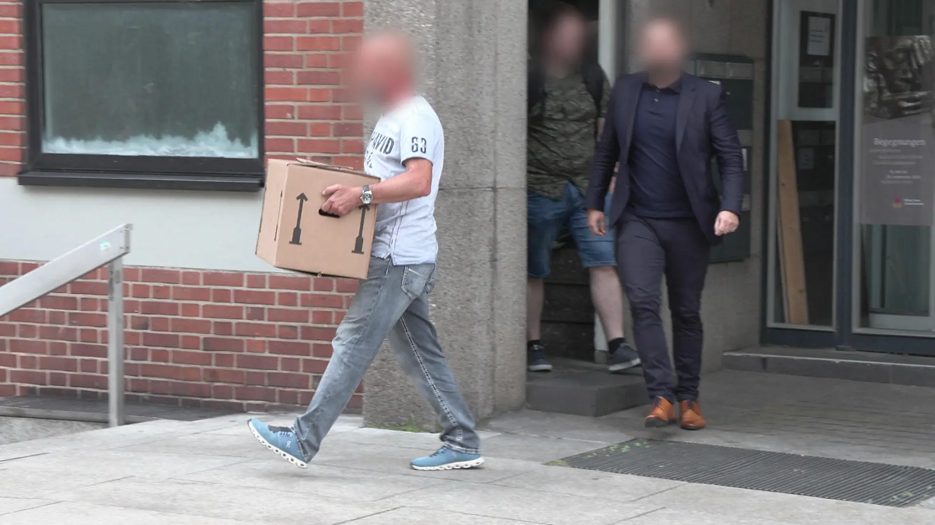27.06.2023, Nordrhein-Westfalen, Köln: Kisten werden bei einer Druchsuchung im Kölner Offizialat aus dem Gebäude getragen.Die Staatsanwaltschaft Köln hat bei ihren Ermittlungen gegen Kardinal Rainer Maria Woelki mehrere Räumlichkeiten unter anderem im Erzbistum durchsuchen lassen. Foto: Vincent Kempf/dpa - ACHTUNG: Person(en) wurde(n) aus rechtlichen Gründen gepixelt +++ dpa-Bildfunk +++