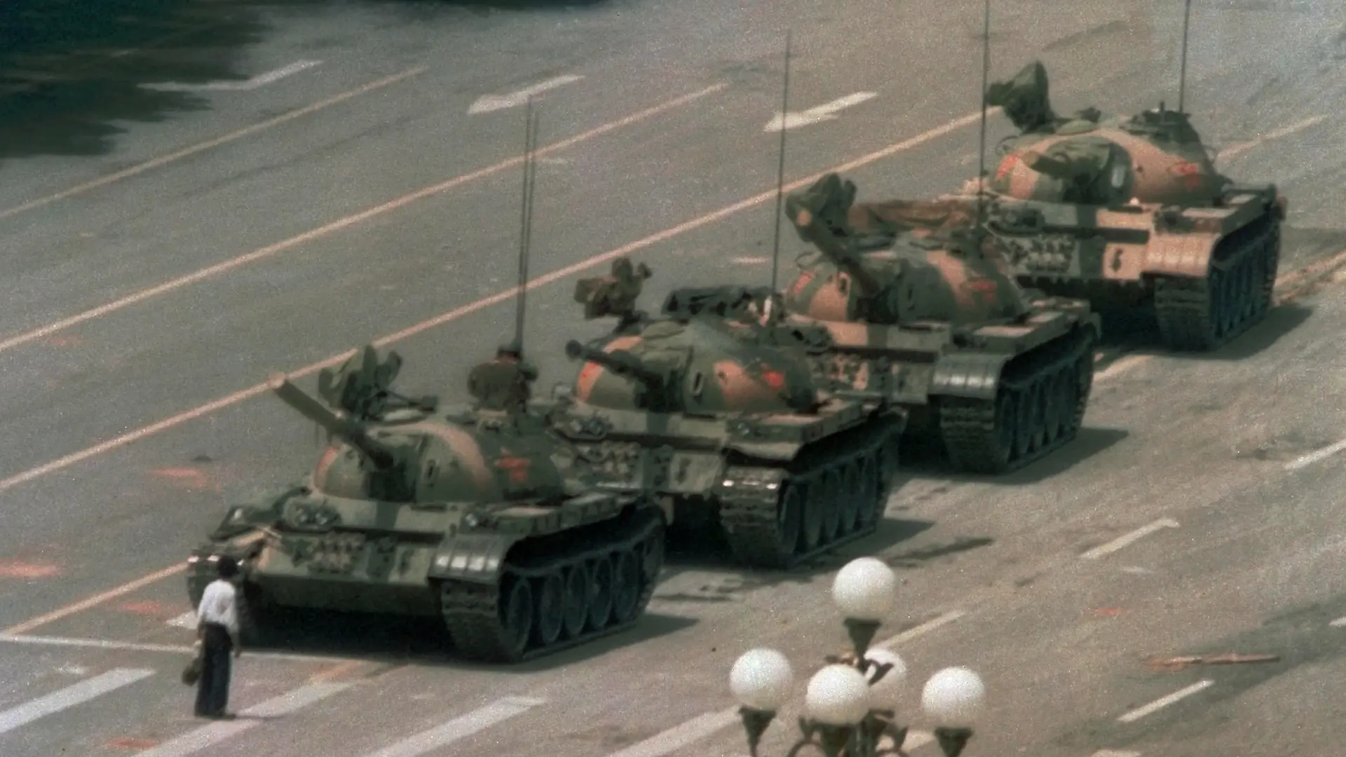 FILE - In this June 5, 1989 file photo, a Chinese man stands alone to block a line of tanks heading east on Beijing's Changan Blvd. from Tiananmen Square in Beijing. A quarter century after the Communist Party¿s attack on demonstrations centered on Tiananmen Square on June 4, 1989, the ruling party prohibits public discussion and 1989 is banned from textbooks and Chinese websites. (AP Photo/Jeff Widener, File)