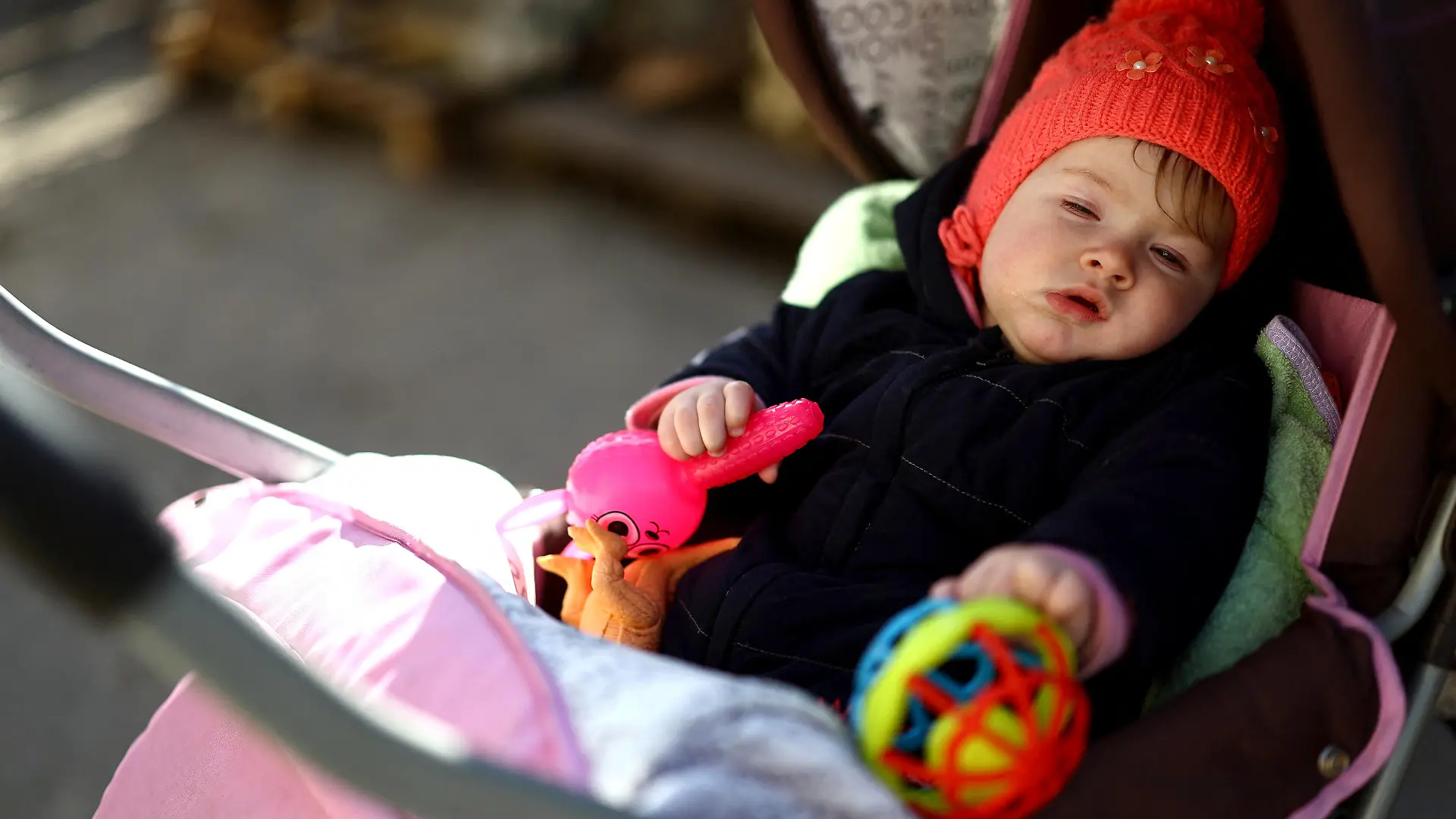 Baby Kateryna, who was born during the Russian occupation, falls asleep in her pram at the family house that is just 1.5 kilometers from the Russian-controlled side of the Dnipro River, where artillery fires daily at Kherson, amid Russia's invasion of Ukraine, in Antonivka, Kherson region, Ukraine, February 21, 2023. REUTERS/Lisi Niesner