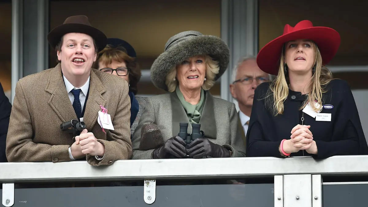 Horse Racing - 2015 Cheltenham Festival - Ladies Day - Cheltenham Racecourse. The Duchess of Cornwall (centre) watches the Neptune Investment Management Novices' Hurdle with son Tom Parker-Bowles (left) and daughter Laura Lopes (right) on Ladies Day during the Cheltenham Festival at Cheltenham Racecourse. Picture date: Wednesday March 11, 2015. See PA story RACING Cheltenham. Picture credit should read: Joe Giddens/PA Wire. URN:22469705