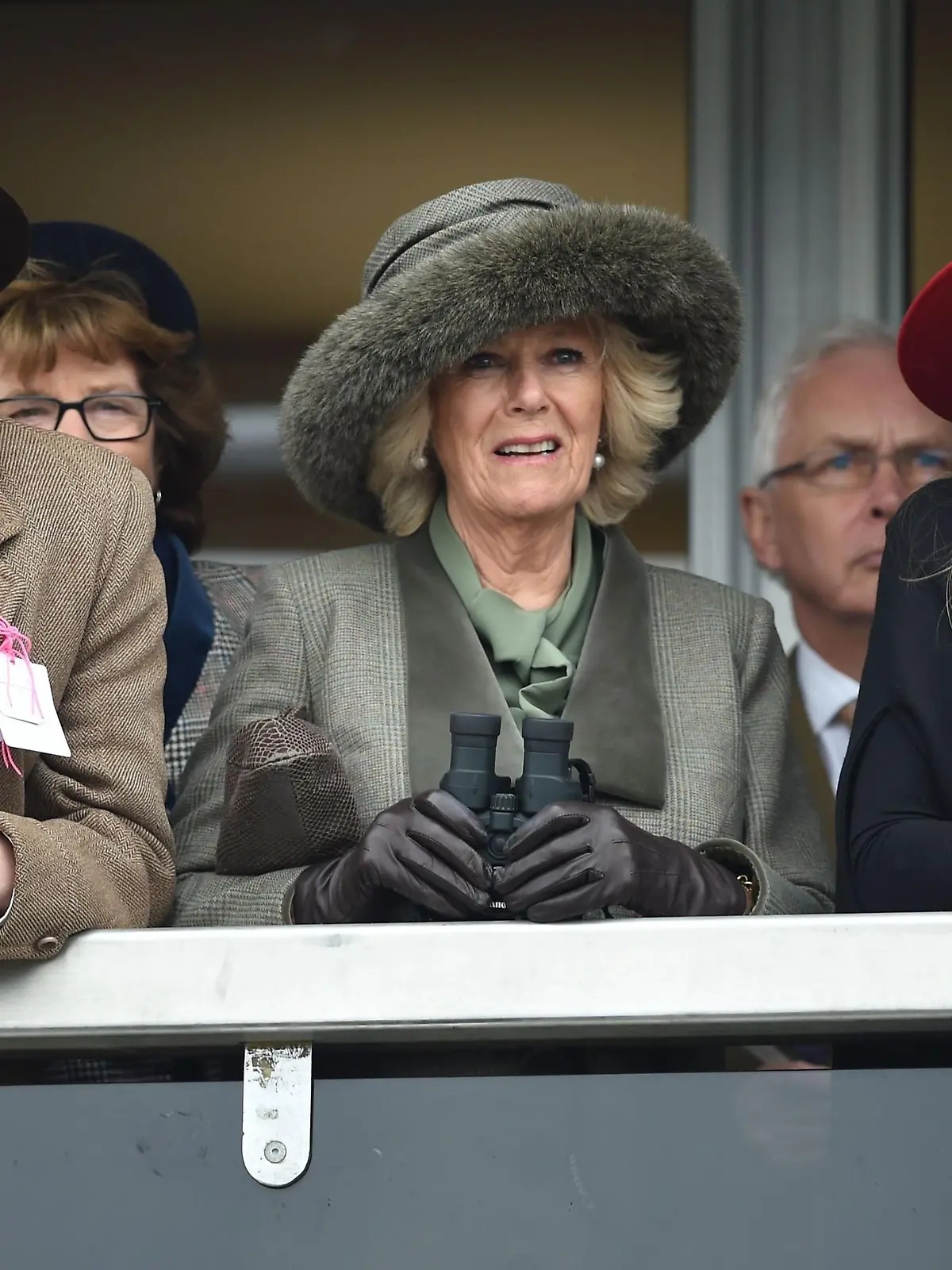 Horse Racing - 2015 Cheltenham Festival - Ladies Day - Cheltenham Racecourse. The Duchess of Cornwall (centre) watches the Neptune Investment Management Novices' Hurdle with son Tom Parker-Bowles (left) and daughter Laura Lopes (right) on Ladies Day during the Cheltenham Festival at Cheltenham Racecourse. Picture date: Wednesday March 11, 2015. See PA story RACING Cheltenham. Picture credit should read: Joe Giddens/PA Wire. URN:22469705