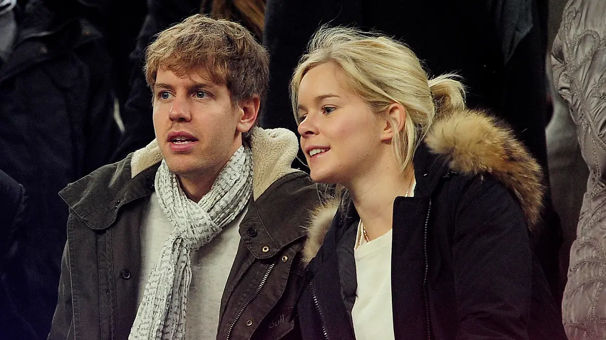 German Formula 1 and Grand Prix driver Sebastian Vettel (L) and his girlfriend Hanna Prater look at the playing field during the Spanish league football match between FC Barcelona and Valencia CF on February 19, 2012, at the Camp Nou stadium in Barcelona. AFP PHOTO / JOSEP LAGO (Photo credit should read JOSEP LAGO/AFP/Getty Images)