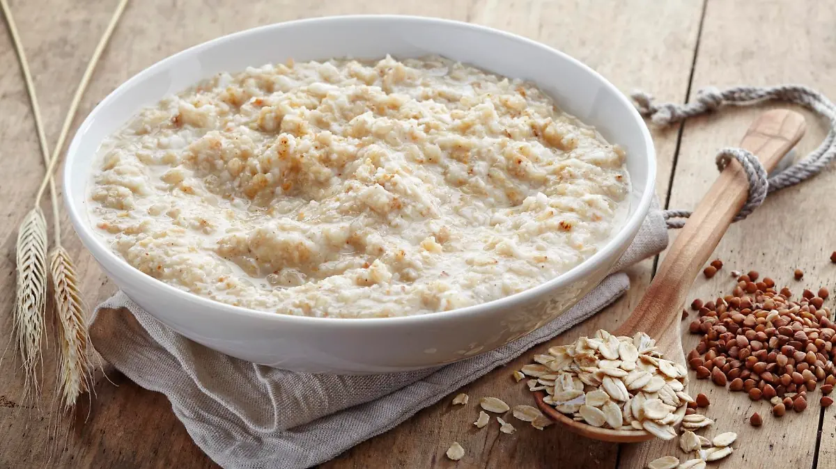 Bowl of various flakes porridge on wooden table