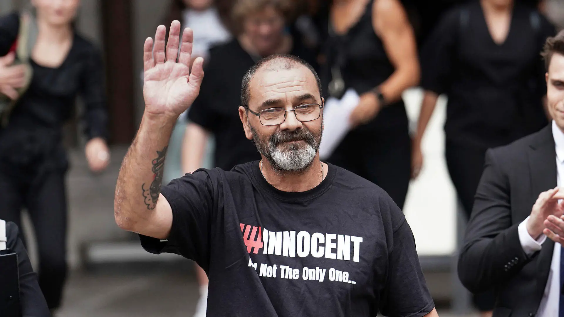 Andrew Malkinson waves as he leave the the Royal Courts of Justice in London, Britain, Wednesday, July 26, 2023. A British man who served nearly 17 years for rape has had his conviction quashed by the country’s Court of Appeal after recently-obtained DNA evidence linked another potential suspect to the crime. Andrew Malkinson, 57, was found guilty of the brutal 2003 attack on a woman in Greater Manchester and jailed for life the following year, with a minimum term of seven years. (Jordan Pettitt/PA via AP)