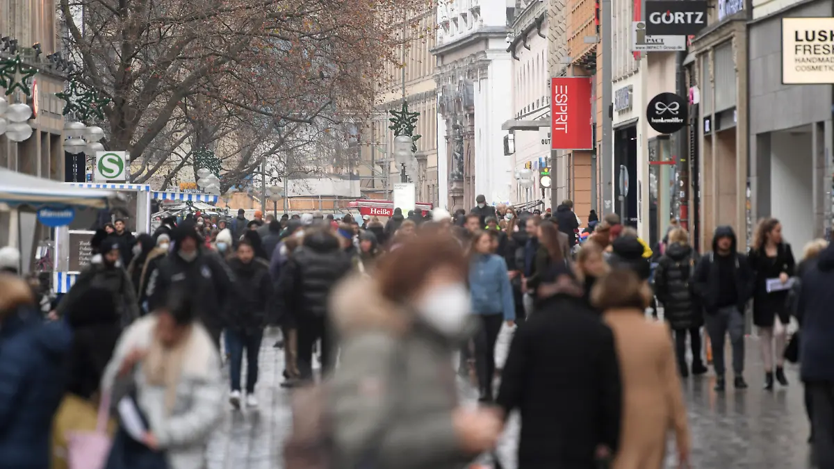 Menschen gehen durch die Kaufingerstraße, eine Einkaufstraße in der Münchner Innenstadt.