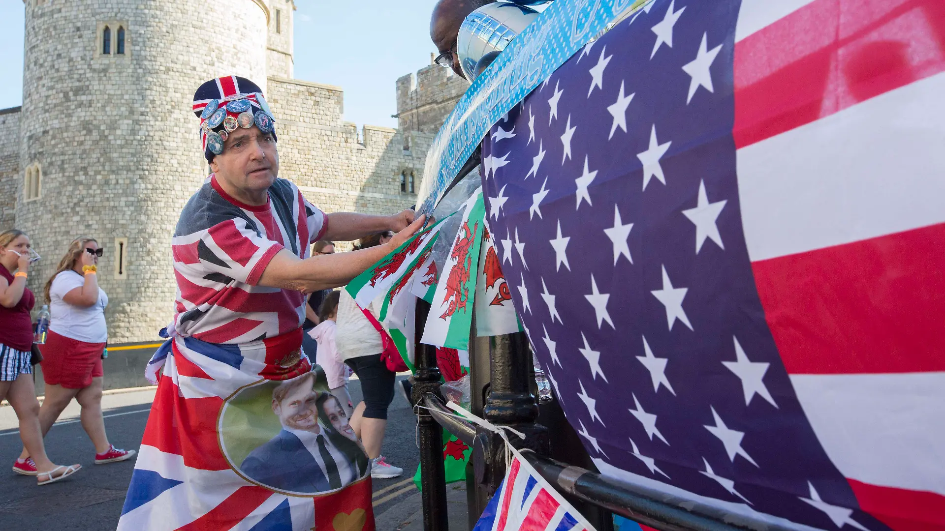 06.07.2019, Großbritannien, Windsor: John Loughrey, Fan der britischen Königsfamilie, hängt vor der Taufe des Sohne von Prinz Harry und Herzogin Meghan vor dem Schloss Windsor Nationalflaggen auf. Archie wird in Windsor bei einer Zeremonie im privaten Kreis getauft. Foto: Rick Findler/PA Wire/dpa +++ dpa-Bildfunk +++