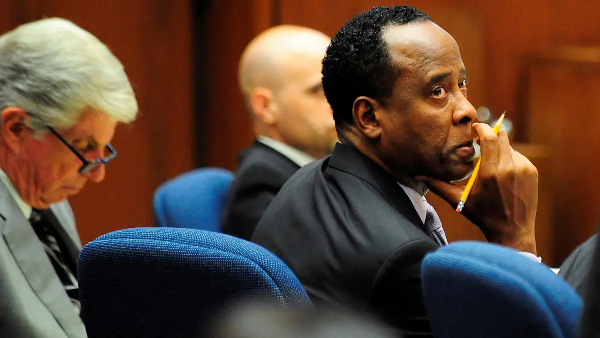 FILE PHOTO: Dr. Conrad Murray watches the proceedings during his trial in the death of pop star Michael Jackson, in Los Angeles October 12, 2011. At left is his attorney J. Michael Flanagan. REUTERS/Robyn Beck/Pool/File Photo PLEASE SEARCH "FROM THE FILES - 10TH ANNIVERSARY OF MICHAEL JACKSON'S DEATH" FOR ALL PICTURES.