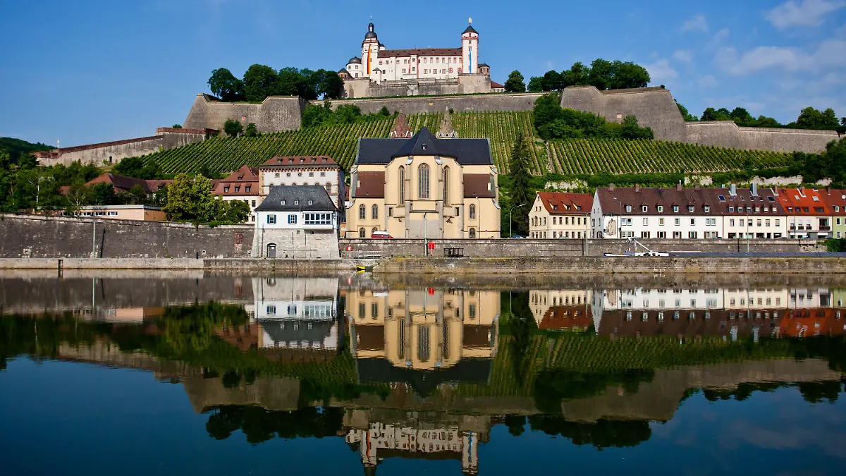 Die Festung Marienberg (o, M) spiegelt sich mit der darunter liegenden romanischen Basilika St. Burkard und anliegenden Häusern am Dienstag (19.06.2012) in Würzburg (Unterfranken) im Main. Laut Vorhersage der Meteorologen wird das Wetter in Bayern in den kommenden Tagen wechselhaft aber warm. Foto: Daniel Karmann dpa/lby +++(c) dpa - Bildfunk+++