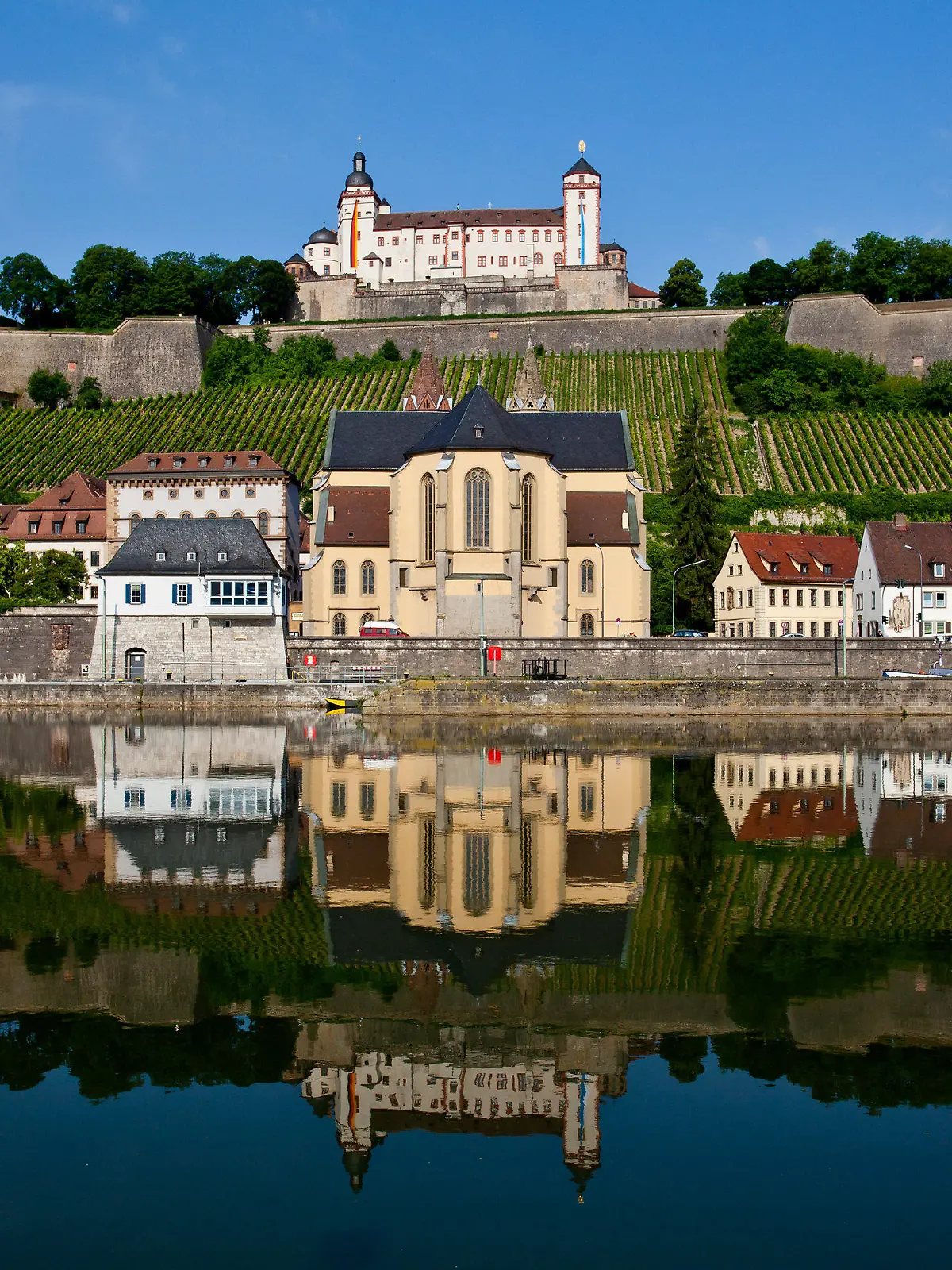 Die Festung Marienberg (o, M) spiegelt sich mit der darunter liegenden romanischen Basilika St. Burkard und anliegenden Häusern am Dienstag (19.06.2012) in Würzburg (Unterfranken) im Main. Laut Vorhersage der Meteorologen wird das Wetter in Bayern in den kommenden Tagen wechselhaft aber warm. Foto: Daniel Karmann dpa/lby  +++(c) dpa - Bildfunk+++