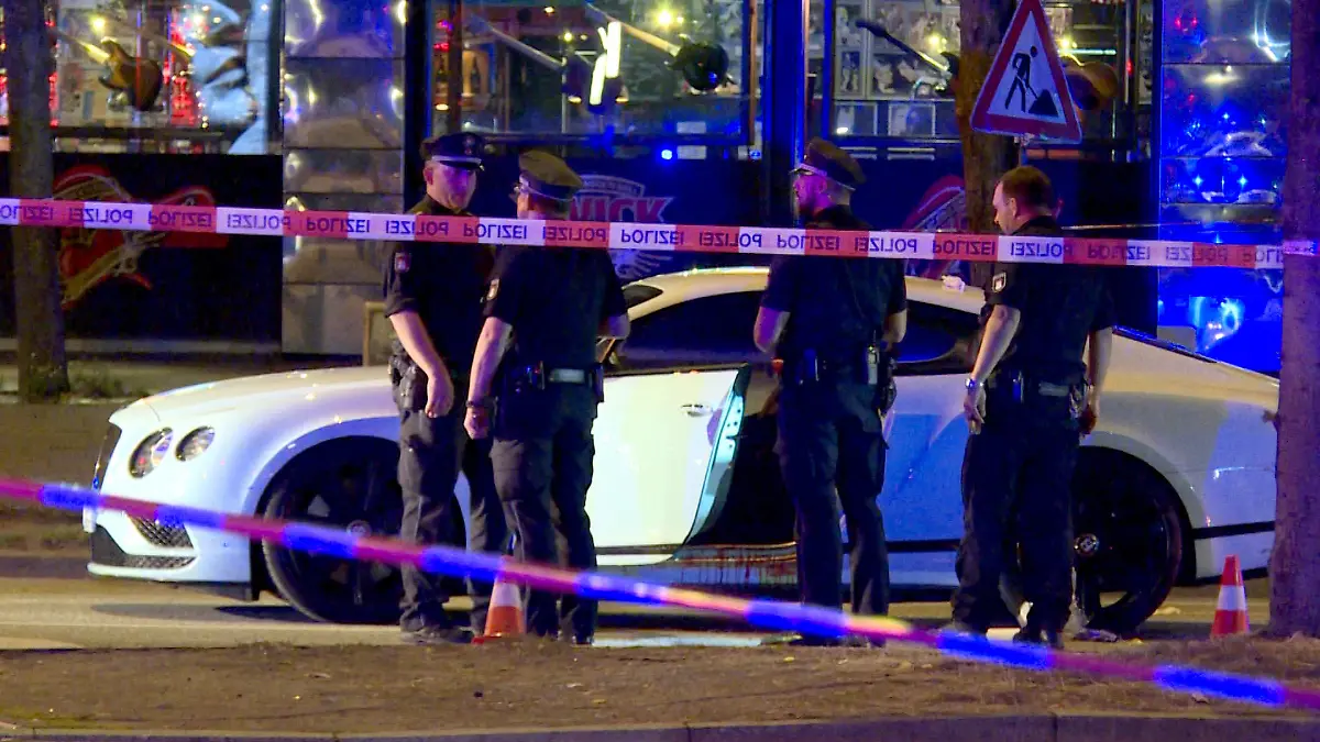 ARCHIV - 27.08.2018, Hamburg: Polizisten stehen neben einem Auto auf dem Millerntorplatz an der Reeperbahn, nachdem Schüsse gefallen waren. Am 03.06.2019 wird voraussichtlich das Urteil im Prozess um die Schüsse auf einen Rockerboss am Millerntor verkündet. Bei der Tat in der Nacht zum 27. August 2018 war der 38-Jährige in seinem Auto lebensgefährlich verletzt worden. Foto: Mücahid Güler/dpa +++ dpa-Bildfunk +++