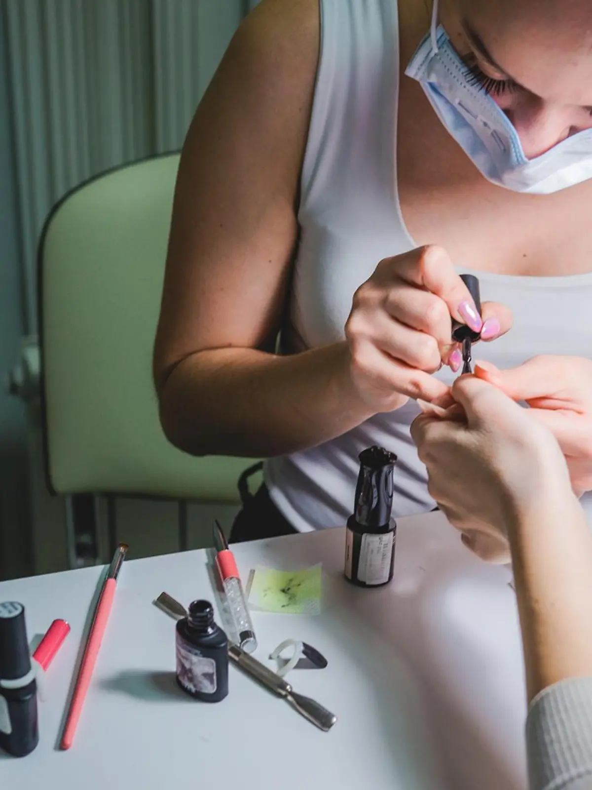 Nagelstudio-Mitarbeiterin gibt Frau eine Maniküre