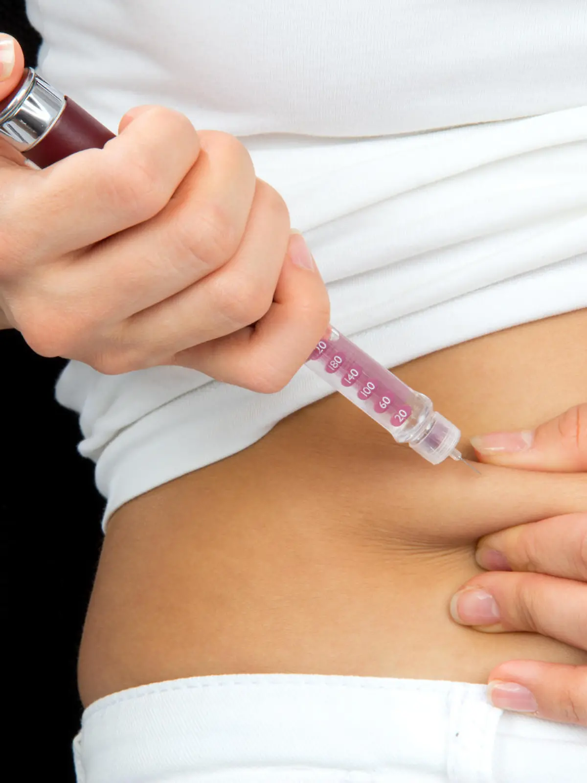 Insulin dependent Diabetes patient make a subcutaneous injection by single use syringe with needle and  insulin into abdomen by doctor prescription 