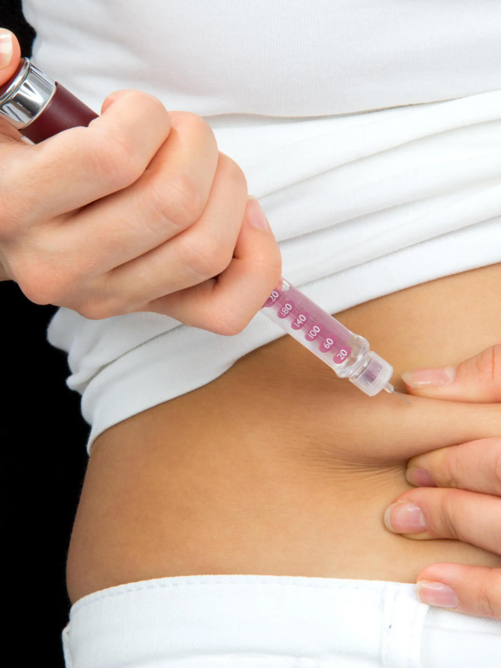 Insulin dependent Diabetes patient make a subcutaneous injection by single use syringe with needle and  insulin into abdomen by doctor prescription 