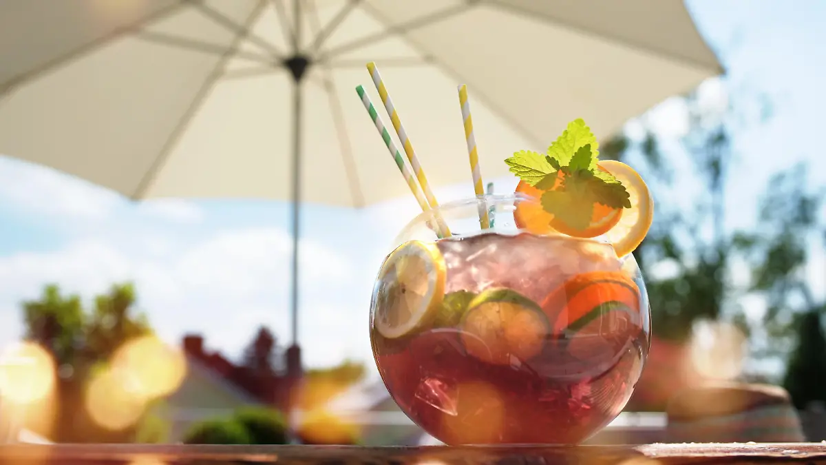 Fresh sangria punch on a summer terrace under a sun umbrella