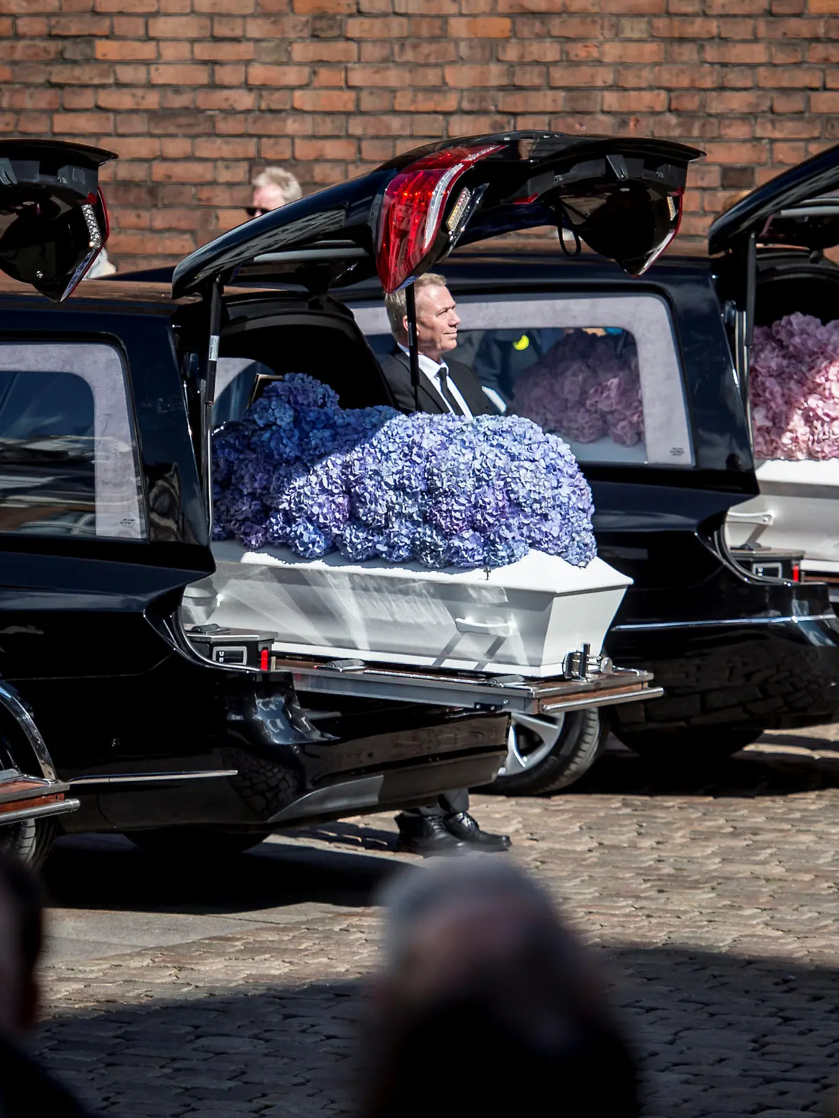 People stand by caskets at the funeral service for the three children of CEO of clothing brand Bestseller, Anders Holch Povlsen, who were victims of a string of suicide bomb attacks in Sri Lanka on April 21, at the Aarhus Cathedral in Aarhus, Denmark Mat 4, 2019. Ritzau Scanpix/Mads Claus Rasmussen/via REUTERS    ATTENTION EDITORS - THIS IMAGE WAS PROVIDED BY A THIRD PARTY. DENMARK OUT. NO COMMERCIAL OR EDITORIAL SALES IN DENMARK.