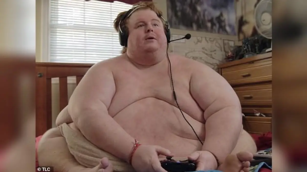 Auf dem Foto sitzt der übergewichtige Casey King mit nacktem Oberkörper auf seinem Sofa.