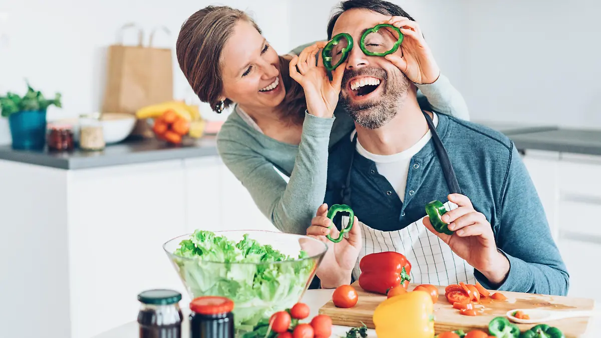 Smiling middle aged couple having fun in the kitchen