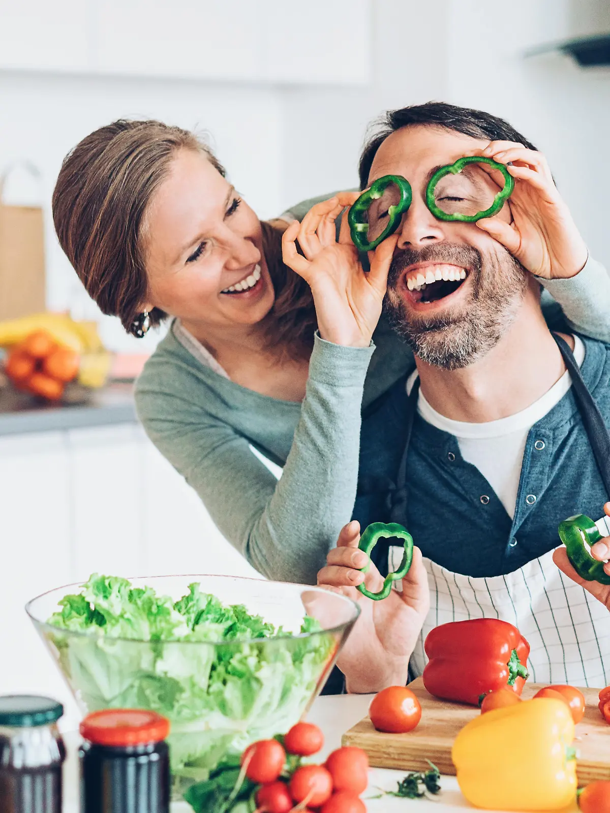 Smiling middle aged couple having fun in the kitchen