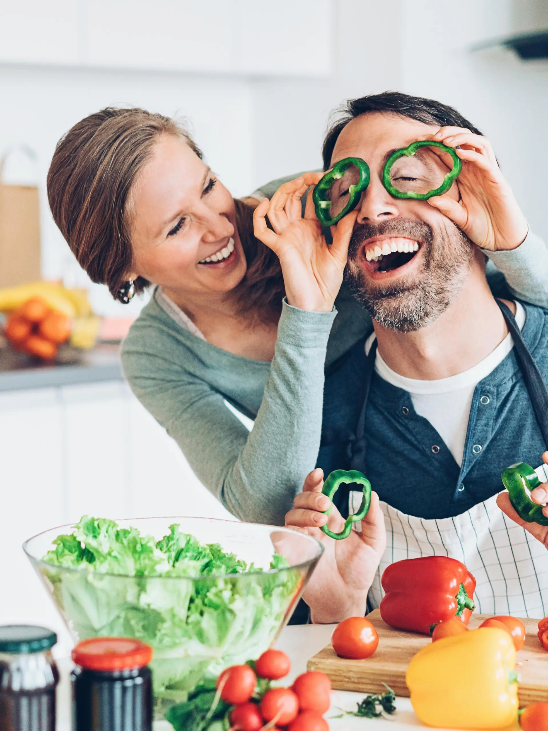 Smiling middle aged couple having fun in the kitchen