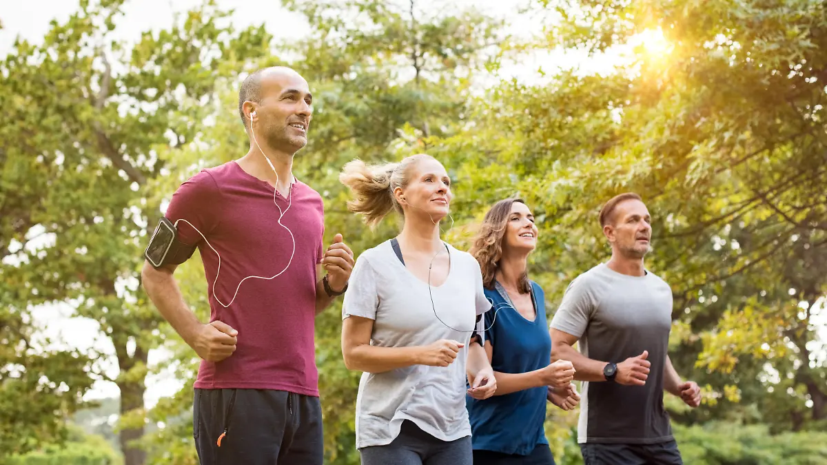 Runners team on morning training together. Group of mature athletes running outside in the park. Group of senior healthy people running outdoor and doing fitness exercises in summer."r