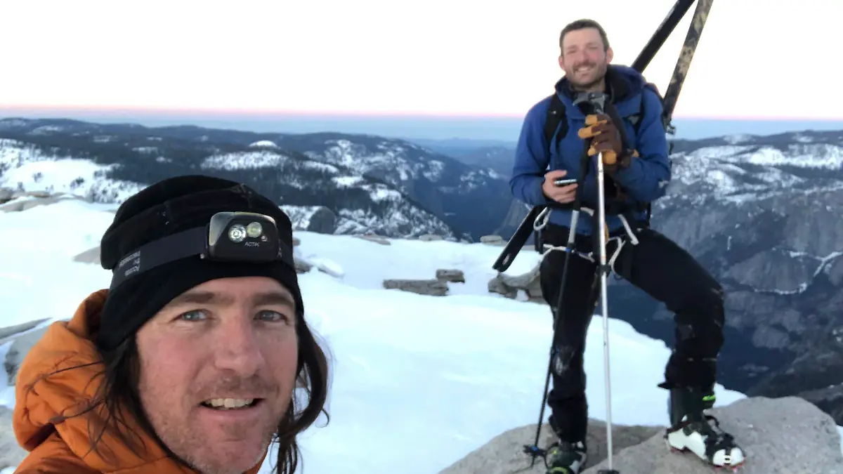 In this photo provided by Jason Torlano, he poses with his friend, Zach Milligan, right, on Half Dome in Yosemite National Park, Calif., on Sunday, Feb. 21, 2021. Two men climbed some 4,000 feet to the top of Yosemite's Half Dome in subfreezing temperatures and skied down the famously steep monolith to the valley floor. Torlano, 45, and Milligan, 40, completed the daring descent in five hours on Sunday by charging down Half Dome's arching back and using ropes to rappel down several sections of bare rock known as the "death slabs," the Fresno Bee reported on Thursday. (Jason Torlano via AP)