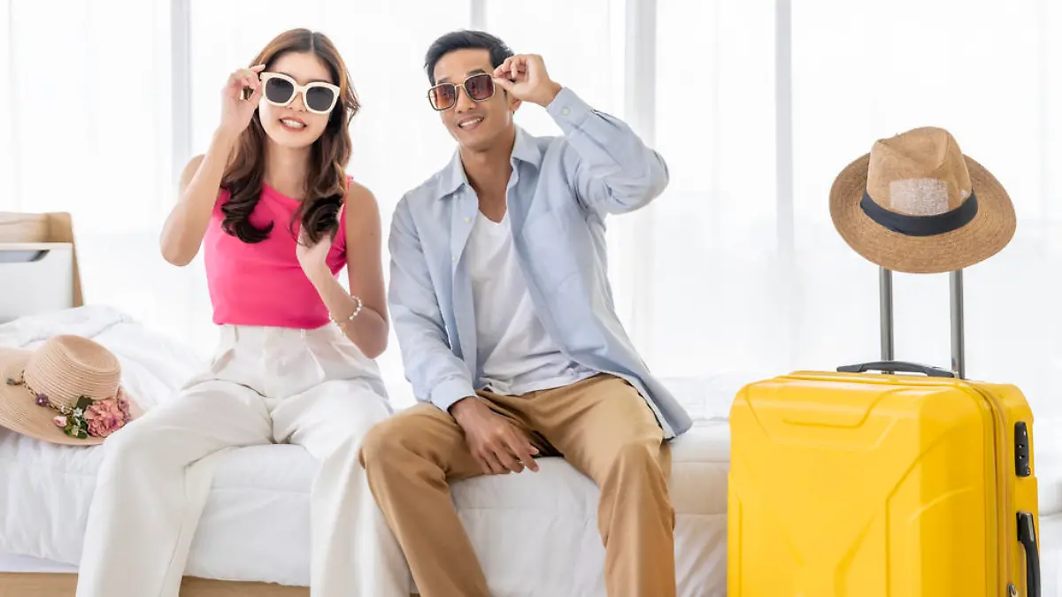 Asian couples are preparing to travel together both domestically and internationally. Have a good travel plan through the Internet. Both of them are happy and excited about going on a trip together.