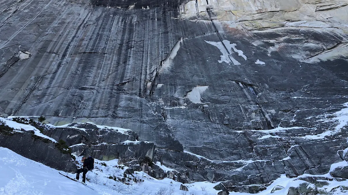 In this photo provided by Jason Torlano, Zach Milligan, lower left, makes his descent down Half Dome in Yosemite National Park, Calif., on Sunday, Feb. 21, 2021. Two men climbed some 4,000 feet to the top of Yosemite's Half Dome in subfreezing temperatures and skied down the famously steep monolith to the valley floor. Jason Torlano, 45, and Zach Milligan, 40, completed the daring descent in five hours on Sunday by charging down Half Dome's arching back and using ropes to rappel down several sections of bare rock known as the "death slabs," the Fresno Bee reported on Thursday. (Jason Torlano via AP)