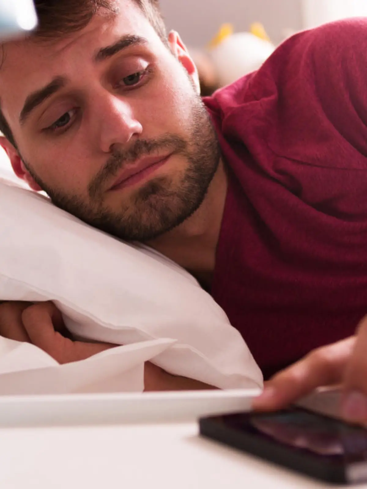 Mann stellt Wecker auf Smartphone