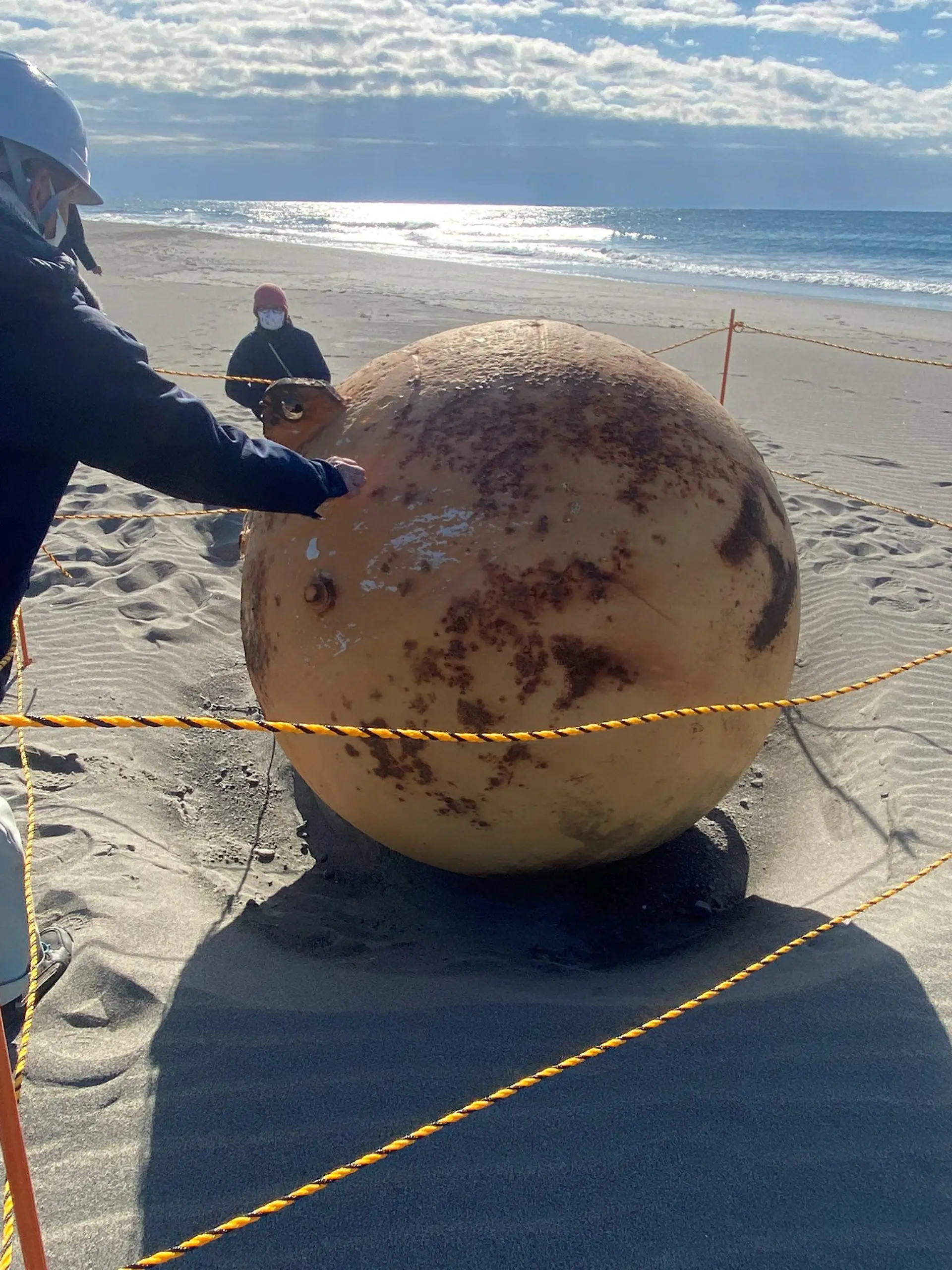 A ball is seen on a beach in Hamamatsu, Japan February 22, 2023 in this still image obtained from social media on  Twitter/@XMiS10C4M6QthSG via REUTERS  THIS IMAGE HAS BEEN SUPPLIED BY A THIRD PARTY. MANDATORY CREDIT. NO RESALES. NO ARCHIVES.