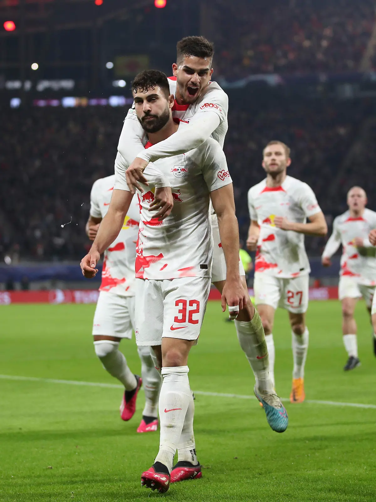 Leipzig's Josko Gvardiol, centre, celebrates with teammates after scoring his side's opening goal during the UEFA Champions League round of sixteen first leg soccer match between RB Leipzig and Manchester City in Leipzig, Germany, Wednesday, Feb. 22, 2023. (AP Photo/Andreas Gora)