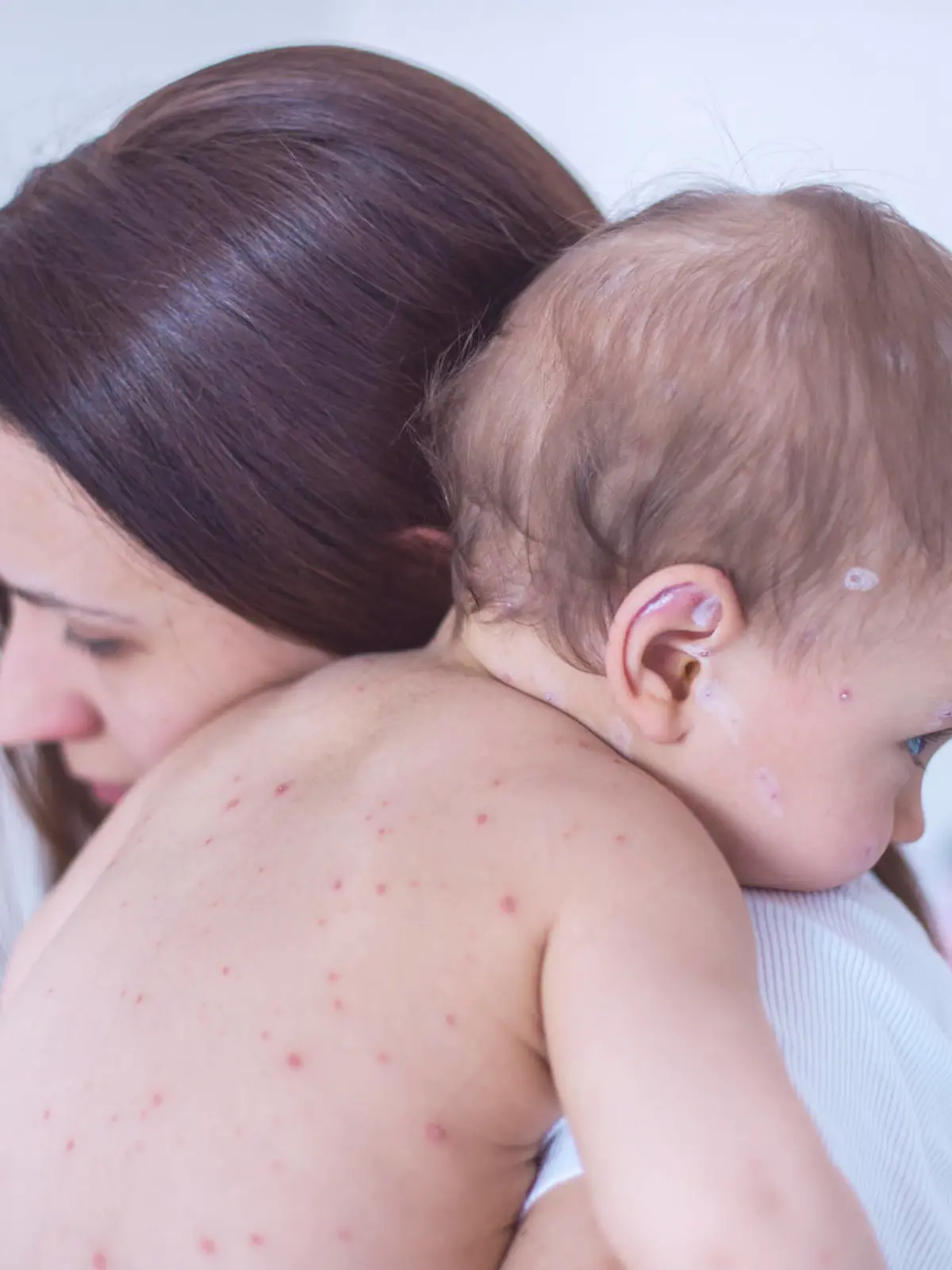 Mother nursing sick child At Home