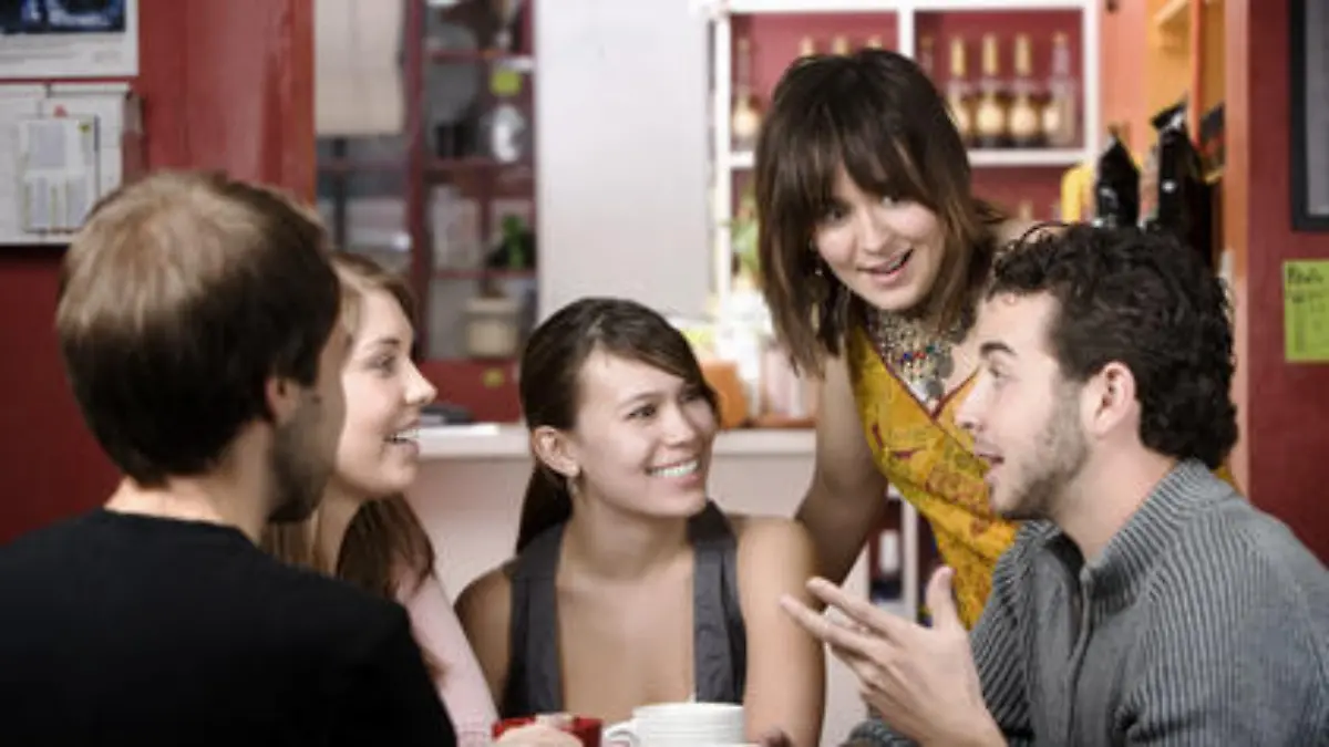 Five young friends in a coffee house