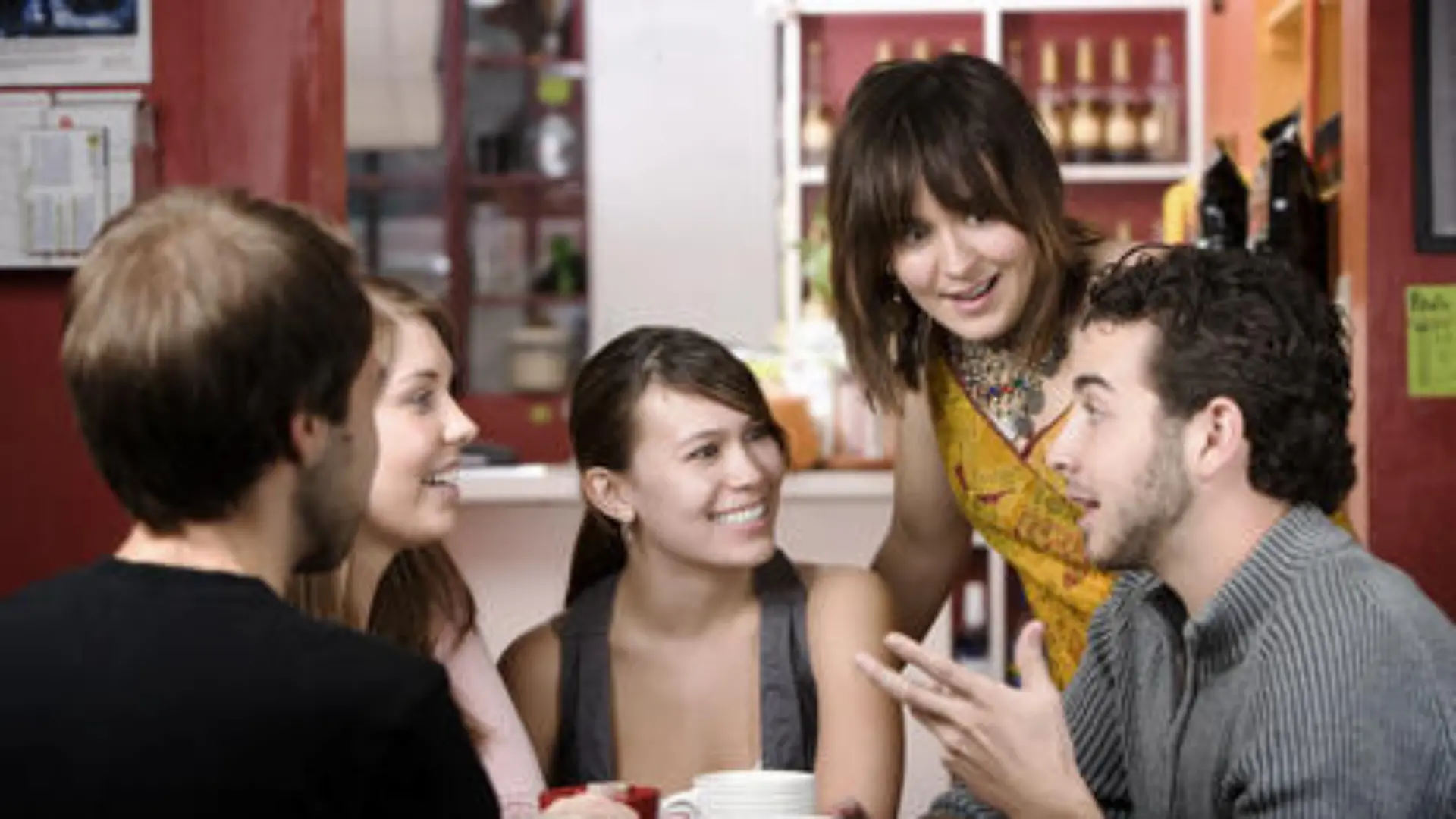 Five young friends in a coffee house