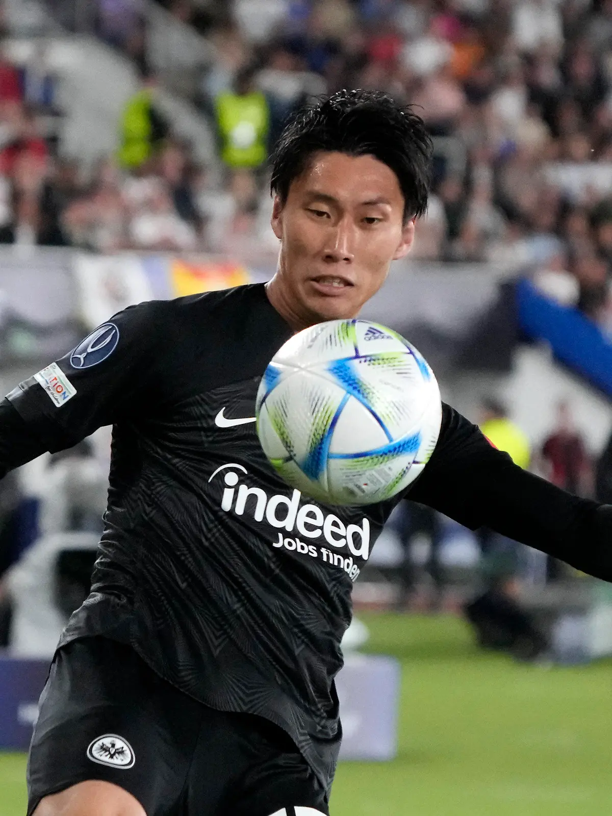Frankfurt's Daichi Kamada kicks the ball during the UEFA Super Cup final soccer match between Real Madrid and Eintracht Frankfurt at Helsinki's Olympic Stadium, Finland, Wednesday, Aug. 10, 2022. (AP Photo/Sergei Grits)