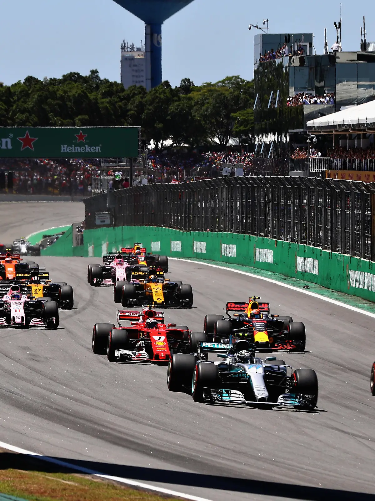 SAO PAULO, BRAZIL - NOVEMBER 12: Sebastian Vettel of Germany driving the (5) Scuderia Ferrari SF70H and Valtteri Bottas driving the (77) Mercedes AMG Petronas F1 Team Mercedes F1 WO8 lead the field towards turn one at the start during the Formula One Grand Prix of Brazil at Autodromo Jose Carlos Pace on November 12, 2017 in Sao Paulo, Brazil.  (Photo by Mark Thompson/Getty Images)