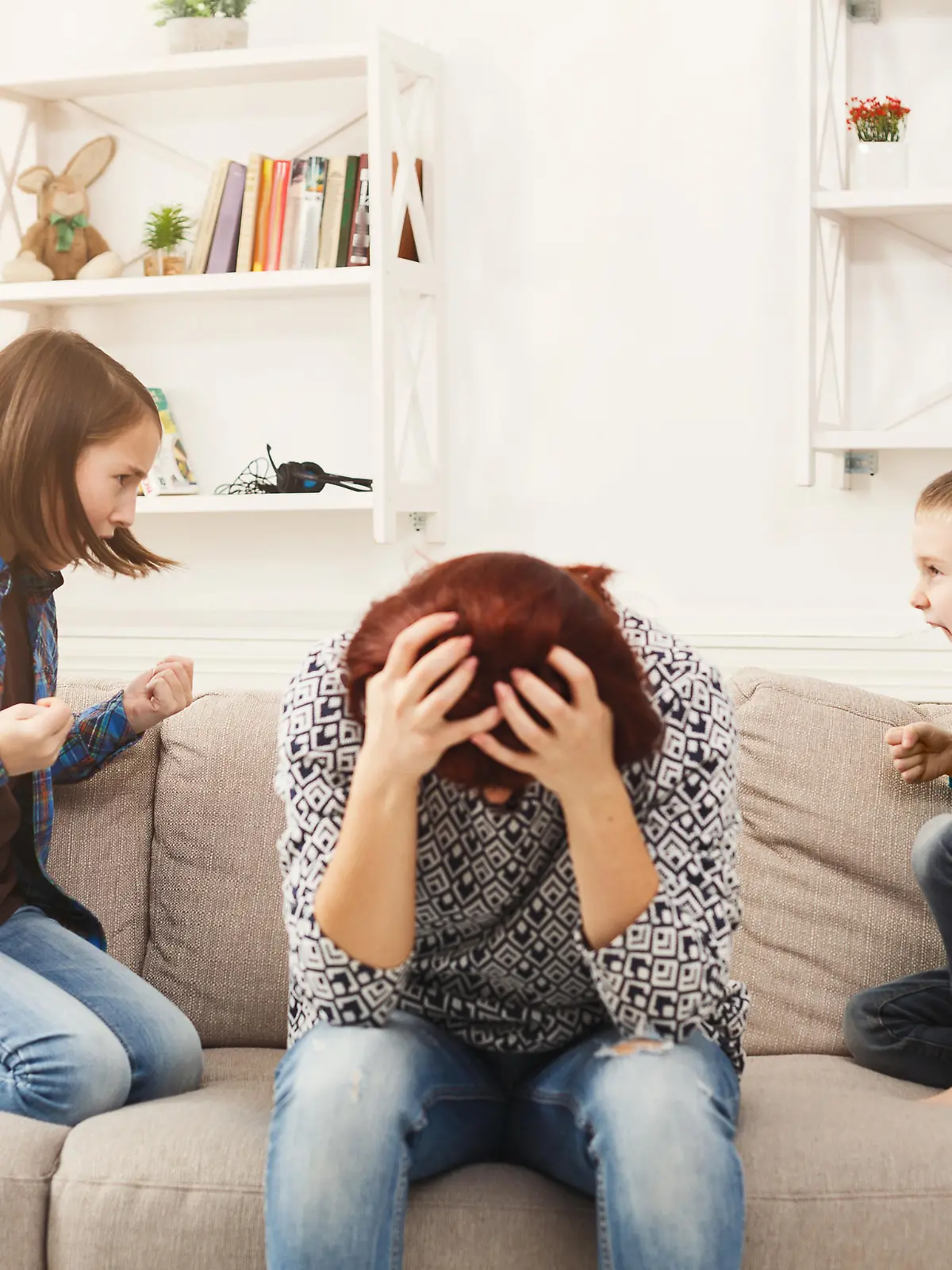 Kids having quarrel over tired mother. Mom is depressed by screaming of children. Problems of motherhood, copy space