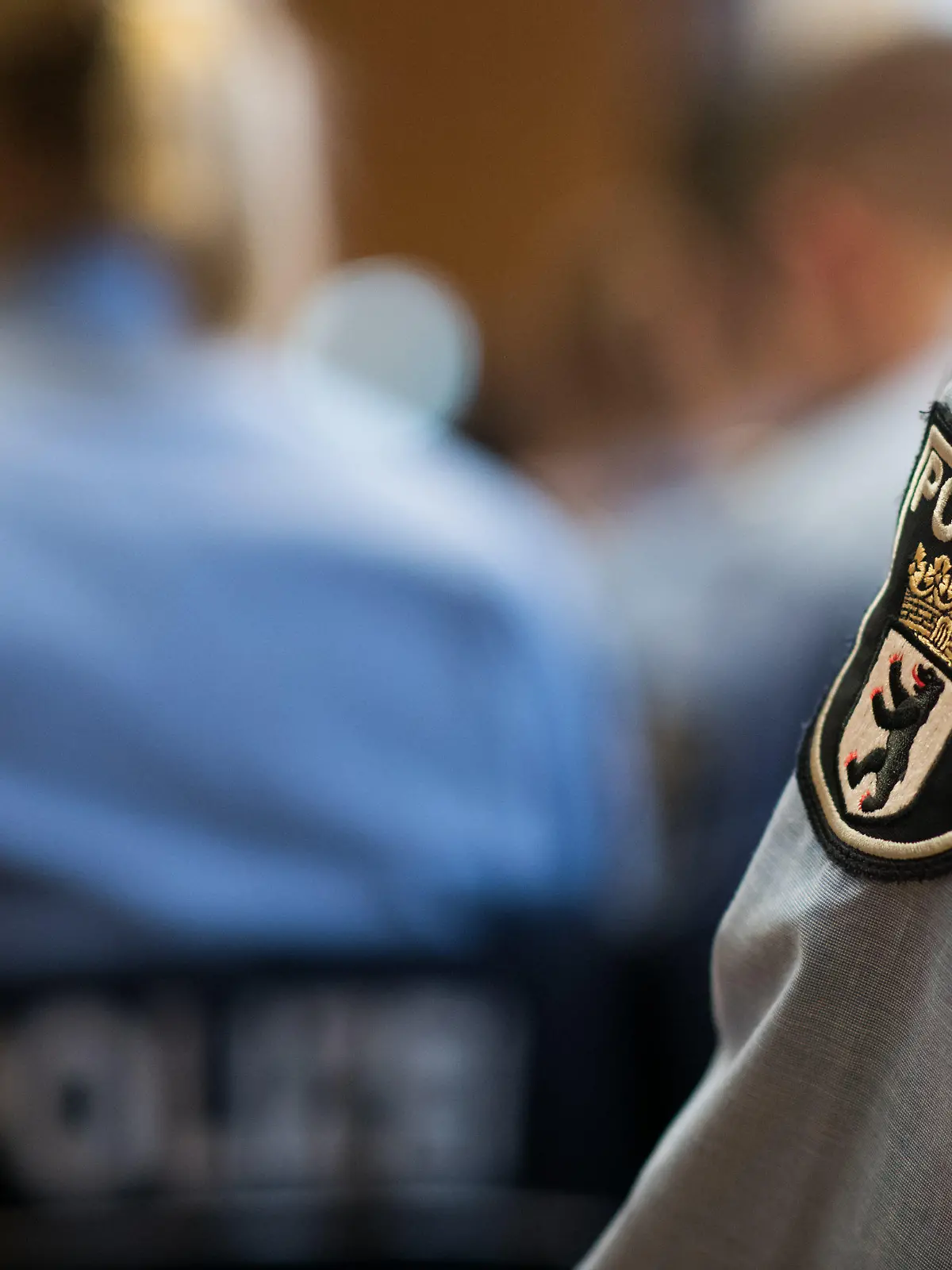 ARCHIV - 29.03.2018, Berlin: Junge Polizisten sitzen bei der Ernennungsfeier für den gehobenen Polizeivollzugsdienst. Große sichtbare Tätowierungen sind nach einer Gerichtsentscheidung gegenwärtig kein Hindernis bei der Bewerbung als Polizist in Berlin. (zu «Gericht: Polizei muss sichtbare Tattoos akzeptieren - Gesetz fehlt» vom 26.07.2018) Foto: Bernd von Jutrczenka/dpa +++ dpa-Bildfunk +++