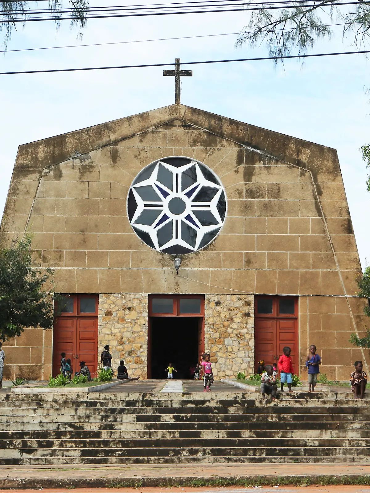 Children play outside a Roman Catholic Church in Pemba city on the northeastern coast of Mozambique in this Monday, April, 29, 2019 photo. Situated in the heart of an ethnically diverse city ravaged by Cyclone Kenneth, the Maria Auxiladora parish is housing close to 1000 people displaced by the storm which according to aid agencies has affected Cabo Delgado the countrys northern province.(AP Photo/Tsvangirayi Mukwazhi)