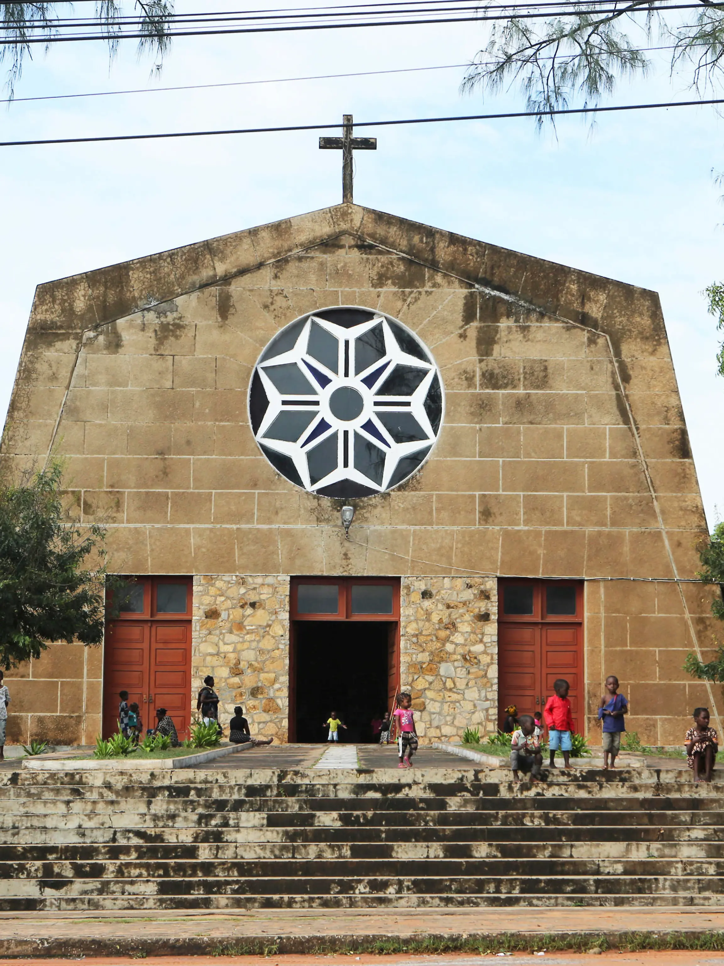 Children play outside a Roman Catholic Church in Pemba city on the northeastern coast of Mozambique in this Monday, April, 29, 2019 photo. Situated in the heart of an ethnically diverse city ravaged by Cyclone Kenneth, the Maria Auxiladora parish is housing close to 1000 people displaced by the storm which according to aid agencies has affected Cabo Delgado the countrys northern province.(AP Photo/Tsvangirayi Mukwazhi)