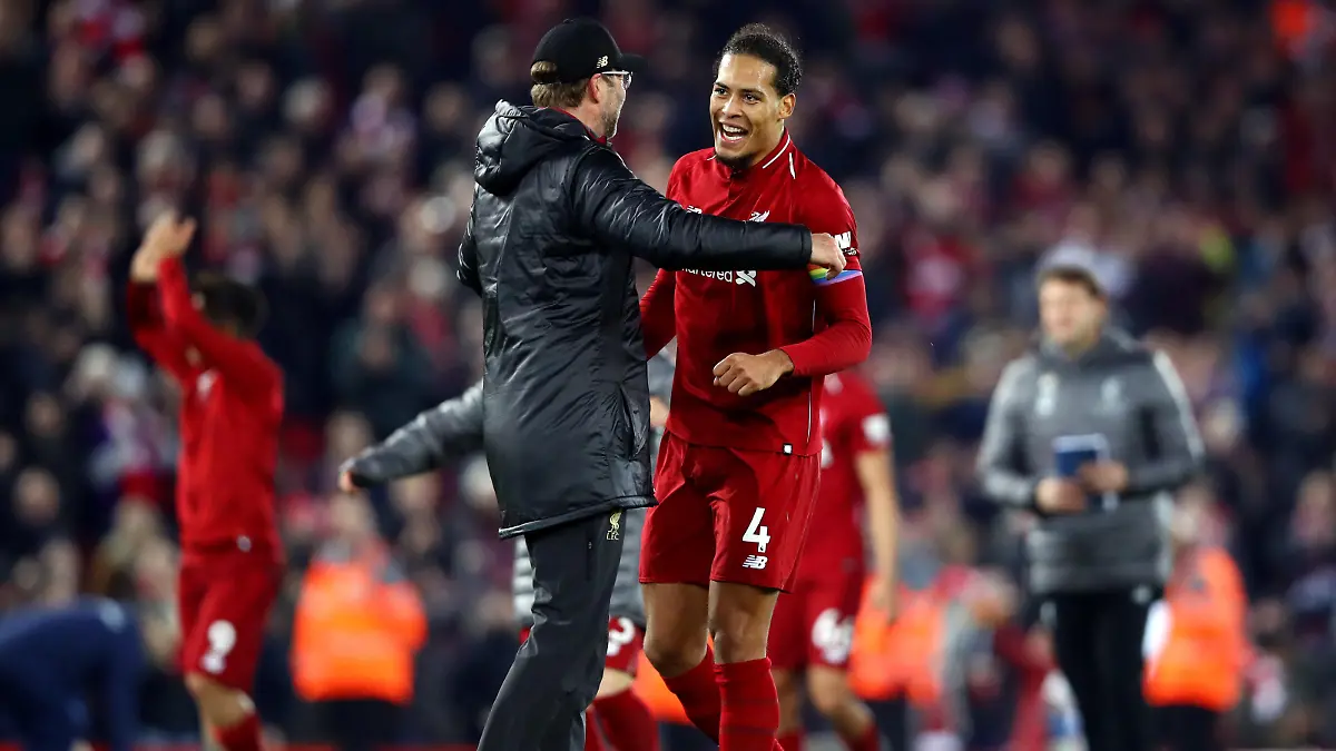 LIVERPOOL, ENGLAND - DECEMBER 02: Jurgen Klopp, Manager of Liverpool and Virgil van Dijk of Liverpool celebrate victory following the Premier League match between Liverpool FC and Everton FC at Anfield on December 2, 2018 in Liverpool, United Kingdom. (Photo by Clive Brunskill/Getty Images)