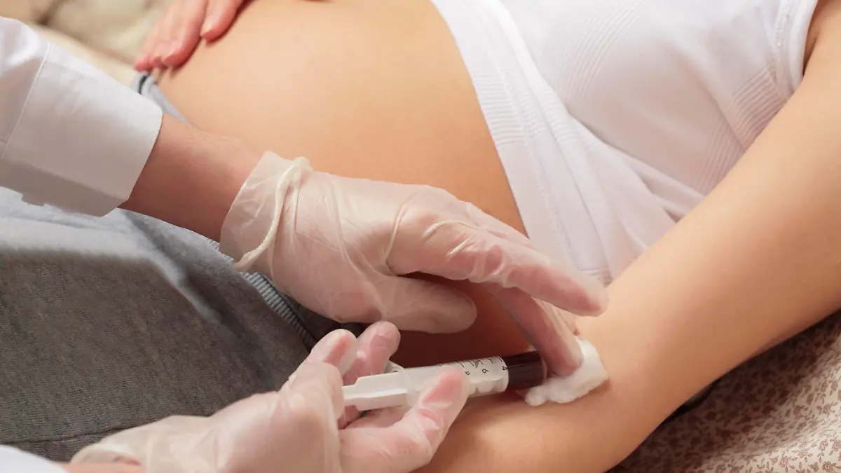 hands of the doctor with syringe, pregnancy, control blood in a laboratory