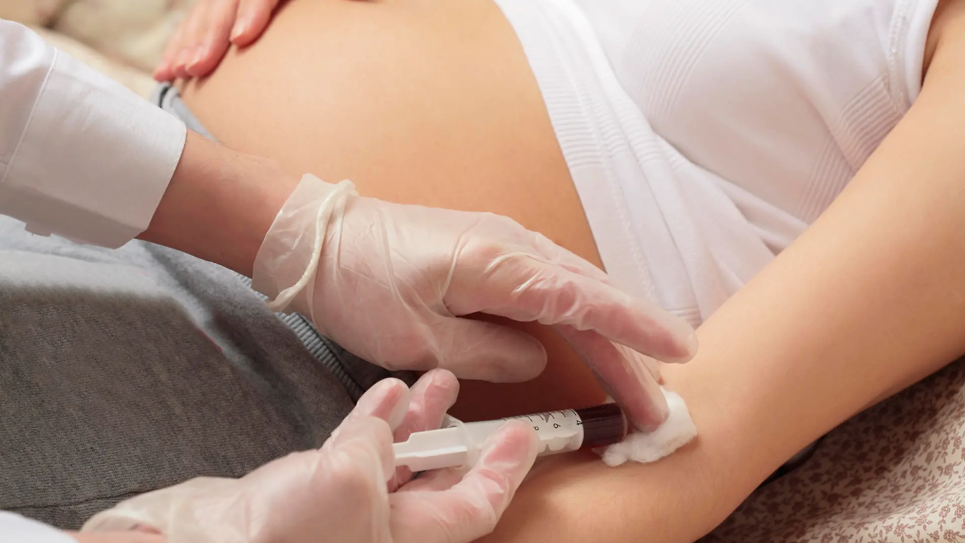 hands of the doctor with syringe, pregnancy, control blood in a laboratory