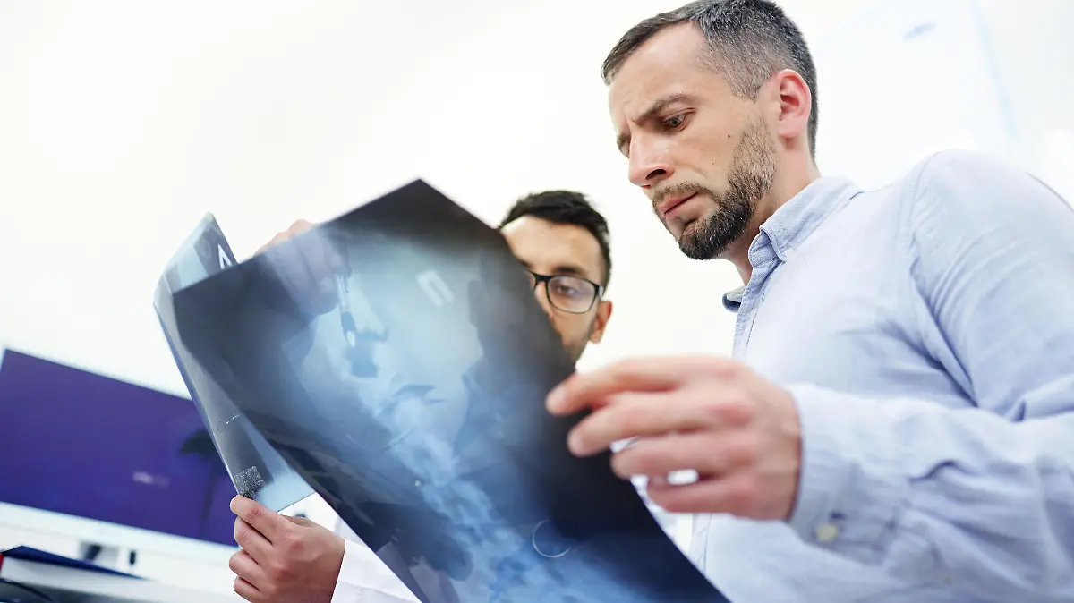 Radiologist explaining patient the problem of his spinal column