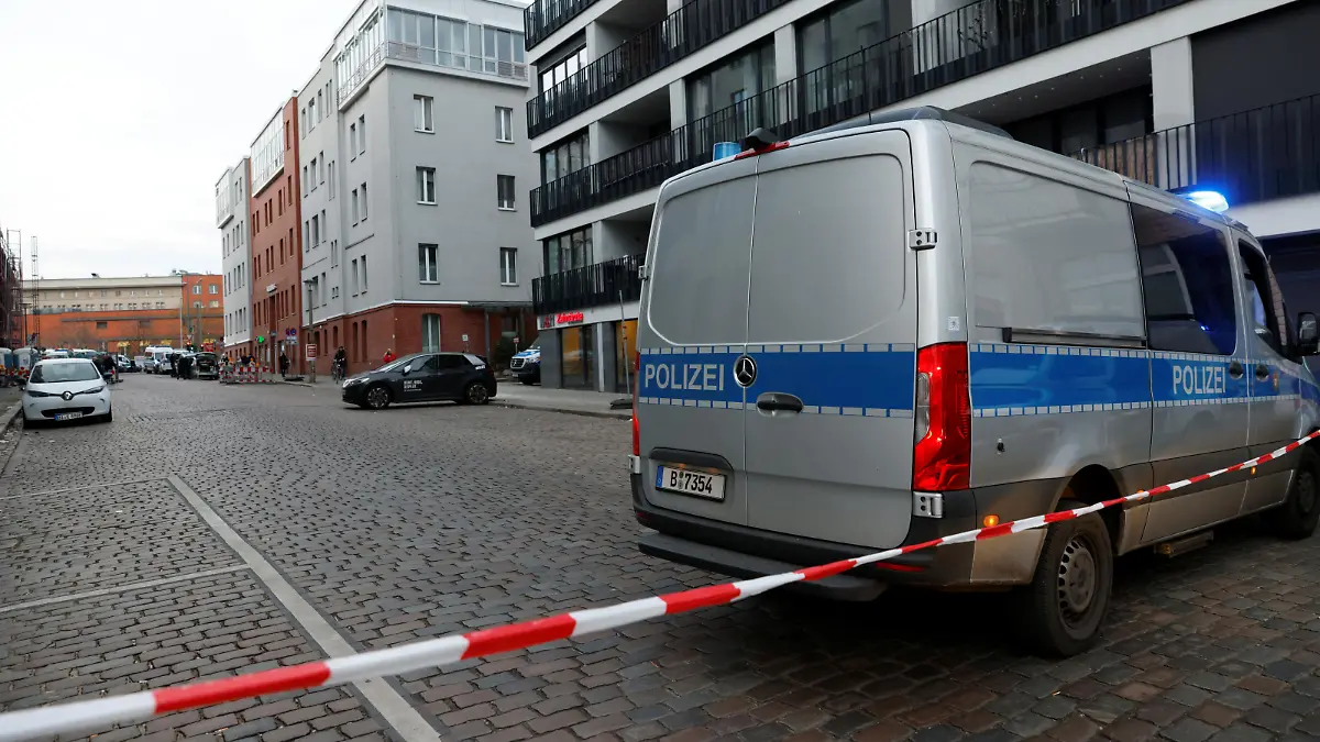 A police vehicle is parked behind a barrier tape as police officers secure the area around a job centre, after an attack alarm was triggered according to police, in Berlin, Germany, February 16, 2023.     REUTERS/Michele Tantussi