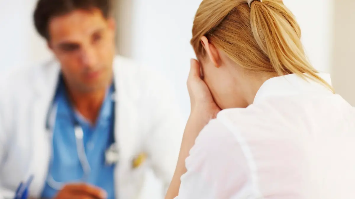 Portrait of female doctor sharing her problems with doctor in office