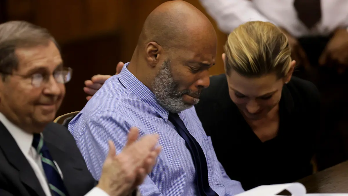 Lamar Johnson, center and his attorneys react on Tuesday, Feb. 14, 2023, after St. Louis Circuit Judge David Mason vacated his murder conviction during a hearing in St. Louis, Mo. Johnson served nearly 28 years of a life sentence for a killing that he has always said he didn't commit. (Christian Gooden/St. Louis Post-Dispatch via AP, Pool)